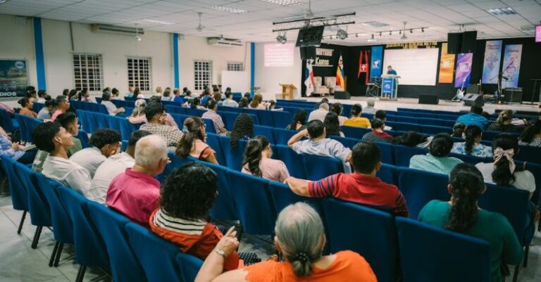 Presentation Principles - A large group of people sitting in chairs in a room