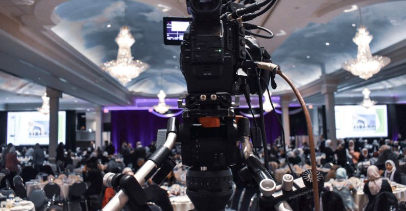 Presentation Tools - Professional video camera recording event in ballroom