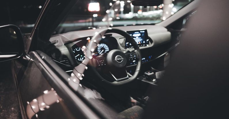 Brand Guidelines - A car interior at night with the steering wheel and dashboard