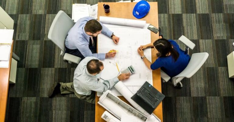 Design Collaboration - Three People Sitting Beside Table