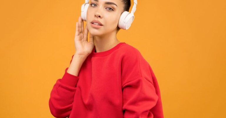 UI Trends - Woman in Red Sweatshirt and Blue Jeans Wearing White Headphones