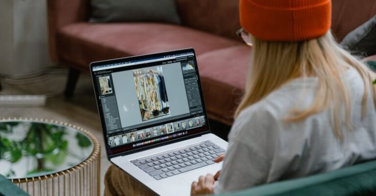 Editing Photos - Woman Sitting on a Sofa and Editing Pictures on a Laptop